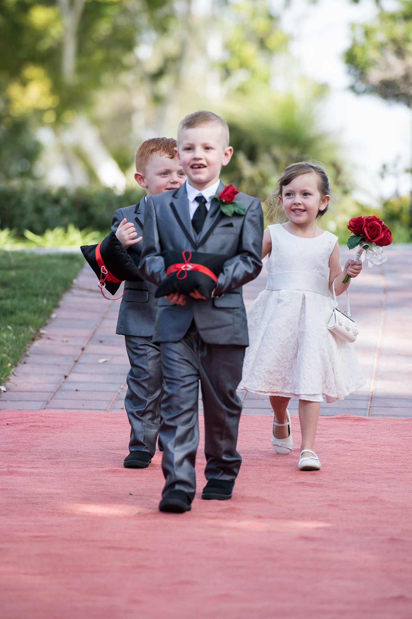 ring bearers and flower girl walk down the aisle