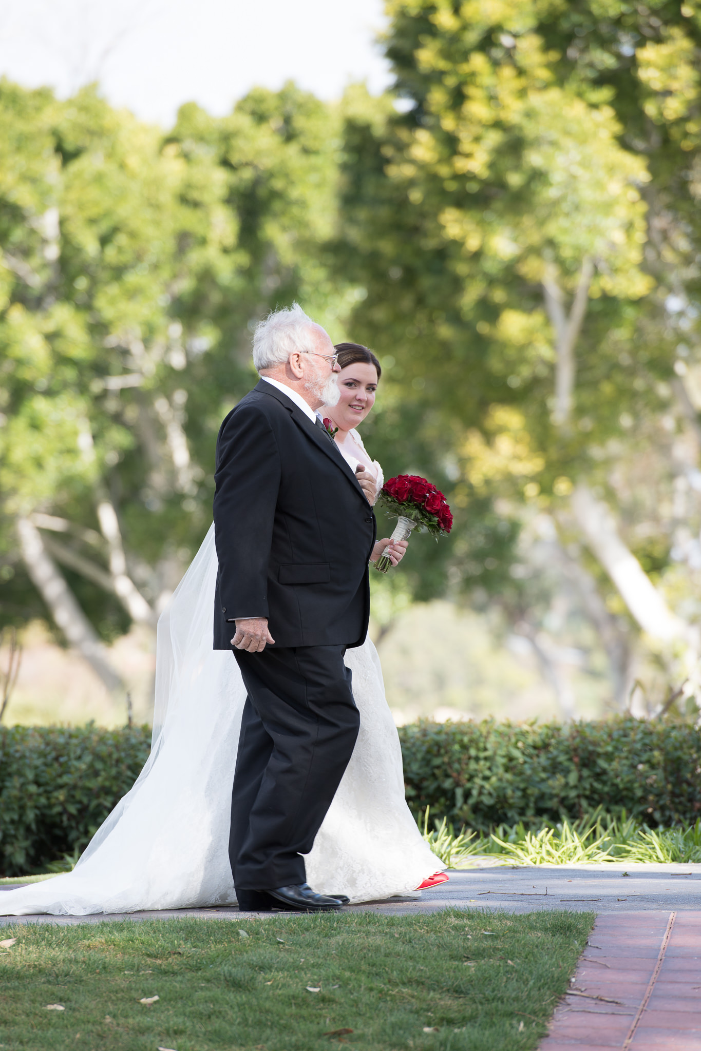 bride peeks around the corner to see her groom