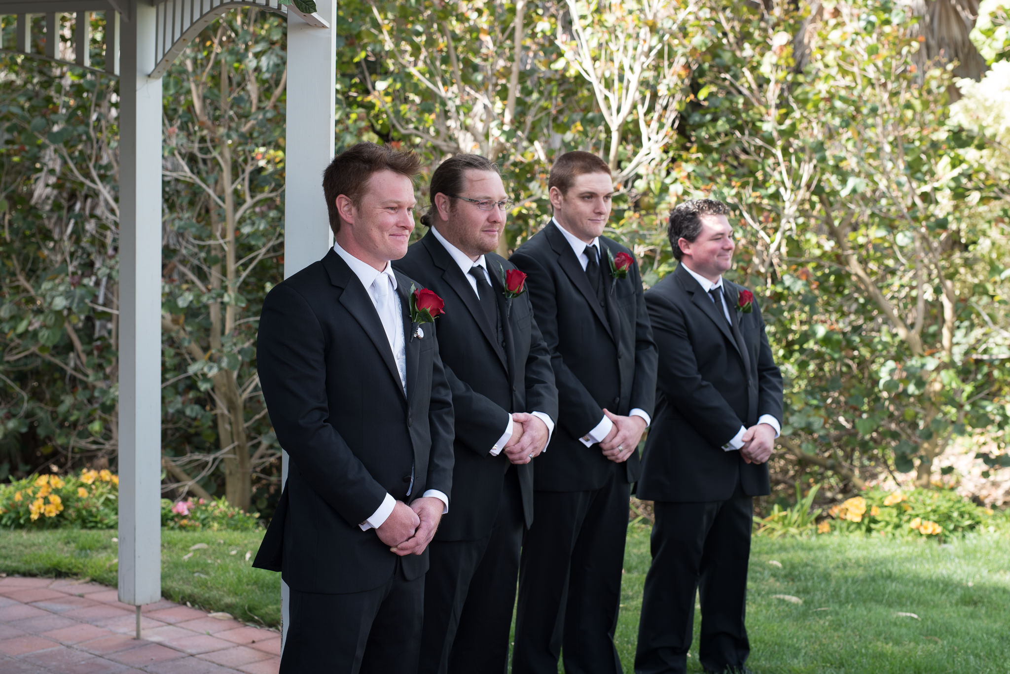 groom and groomsmen smile as he sees the bride