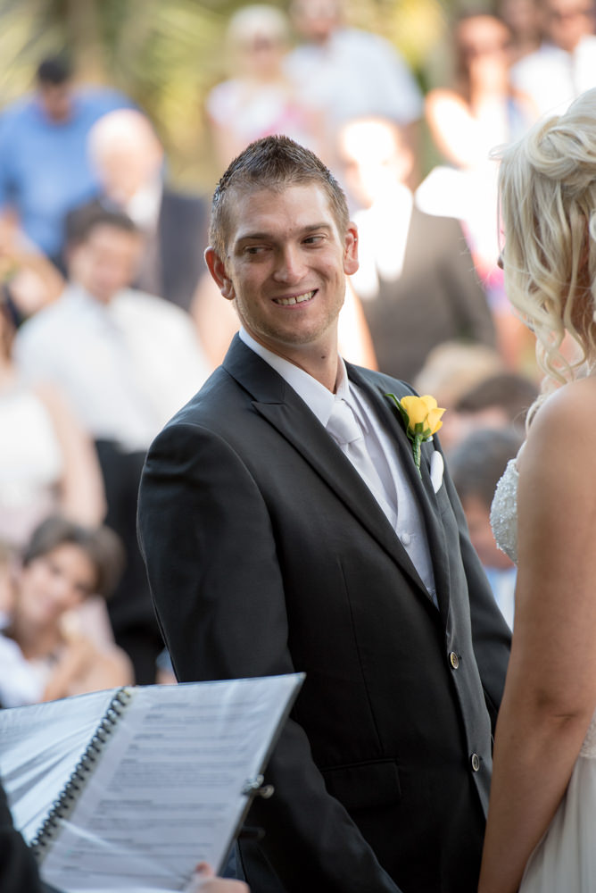 Groom looks at celebrant during ceremony at Joondalup resort