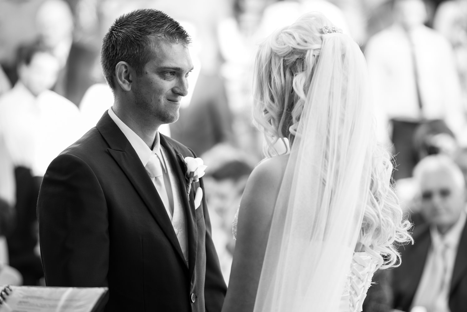 Groom looks at bride during ceremony