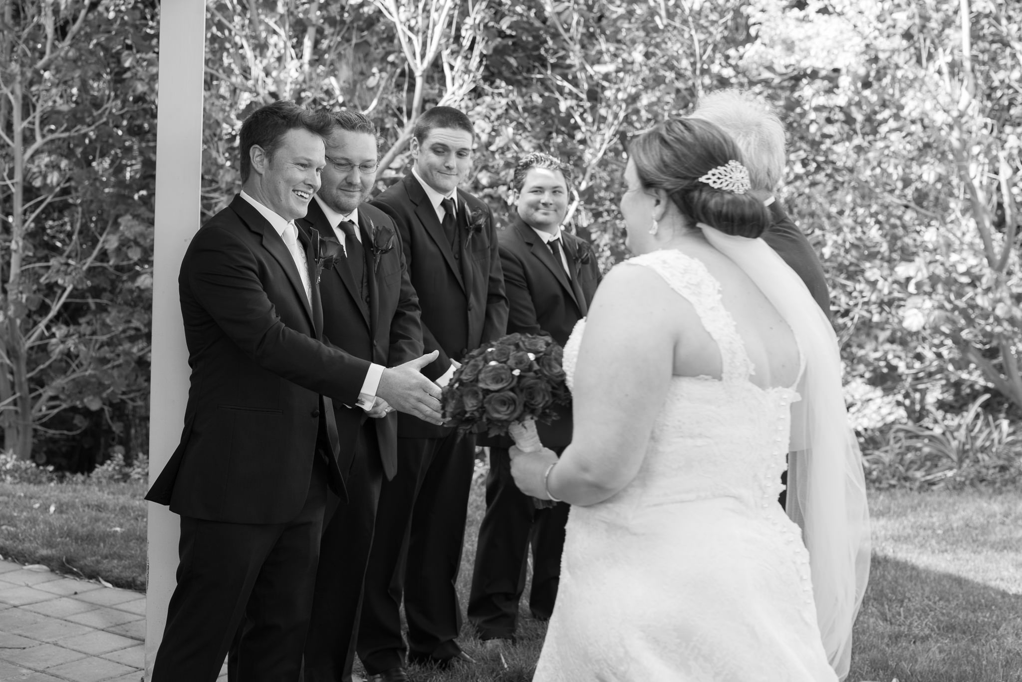 groom shakes the father of the bride's hand as he walks her to the ceremony