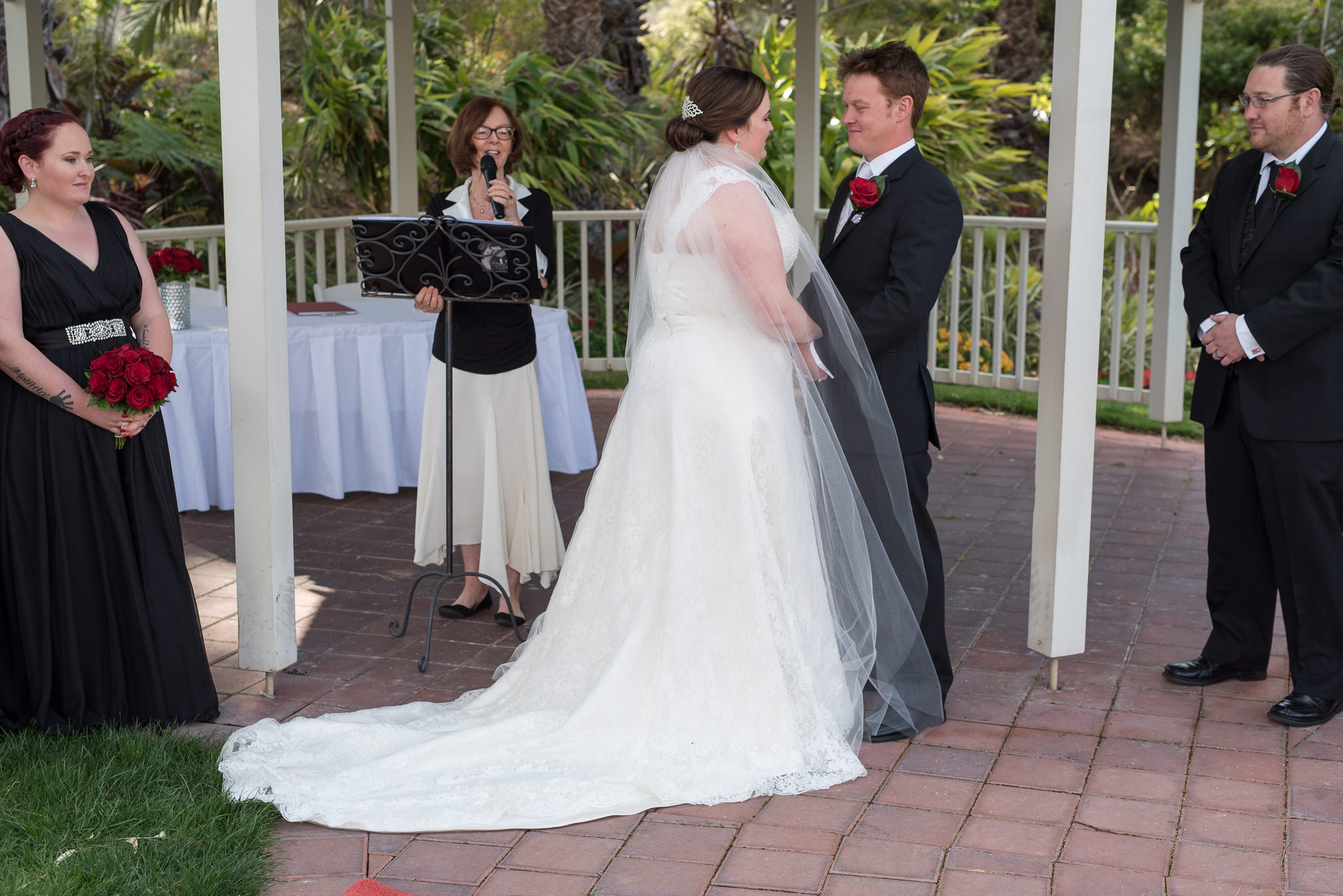 bride and groom look at each other while celebrant begins wedding ceremony