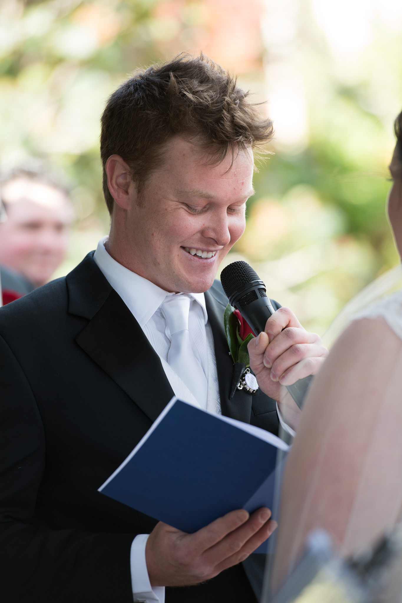 groom smiling saying his vows