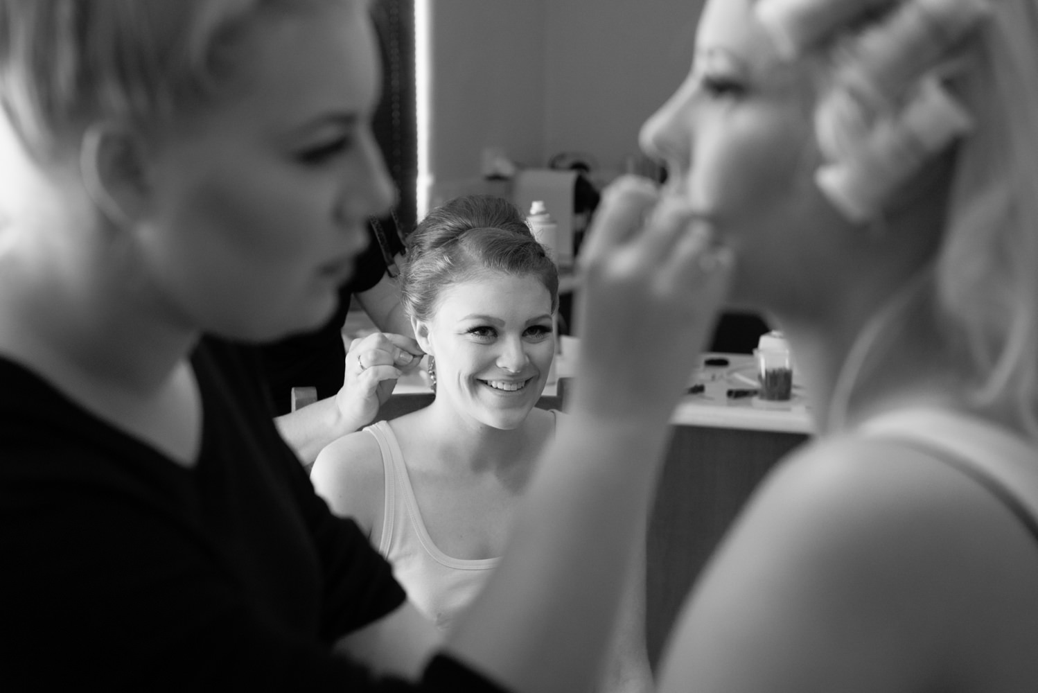 Maid of honour smiling at bride