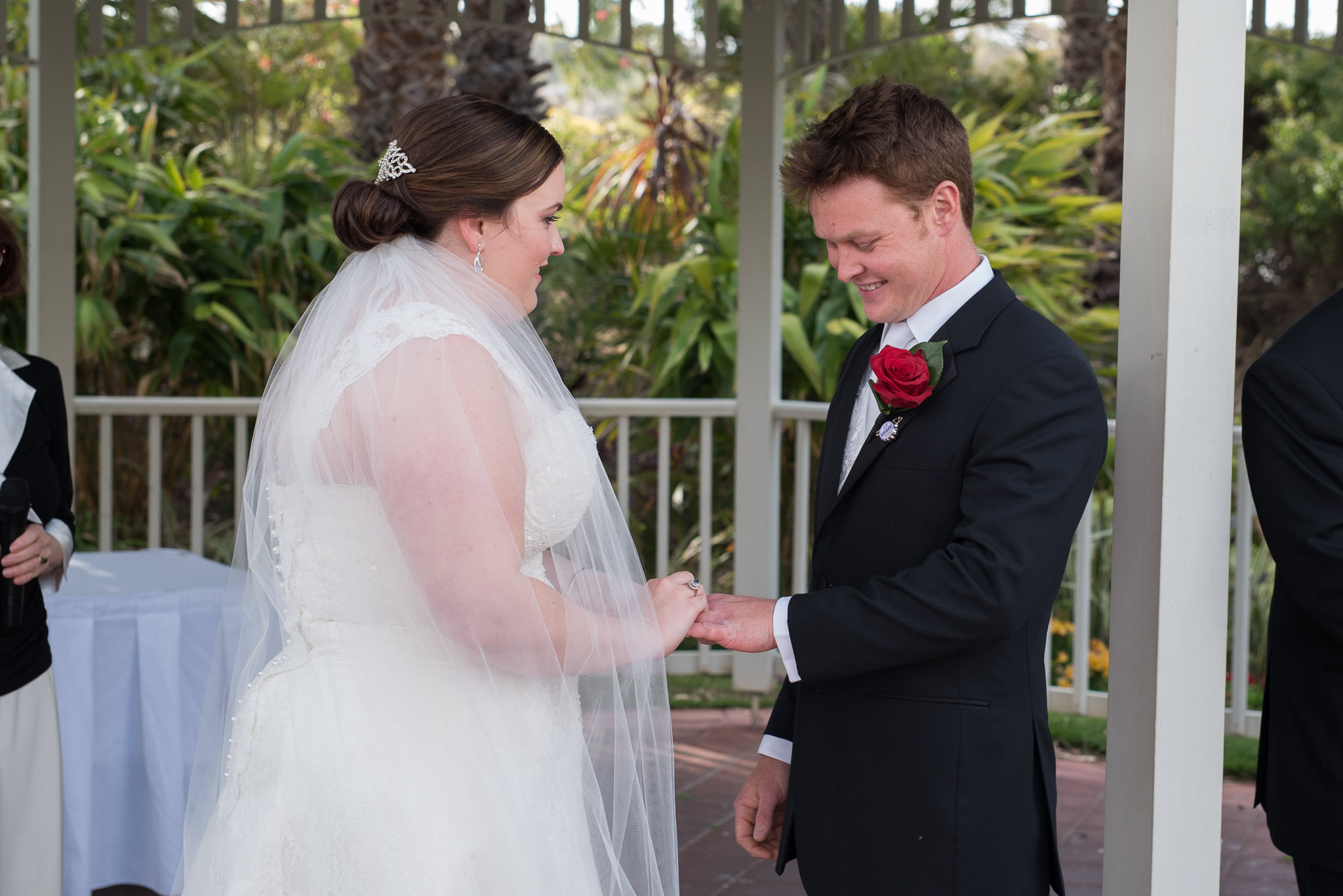 bride places ring on groom's finger