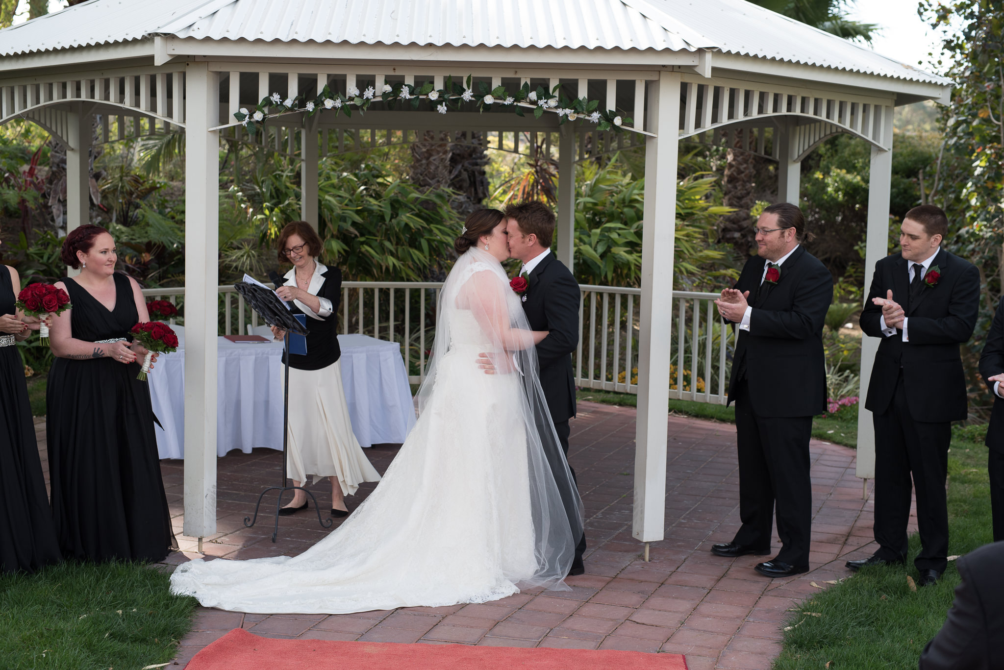 bride and groom kiss during ceremony