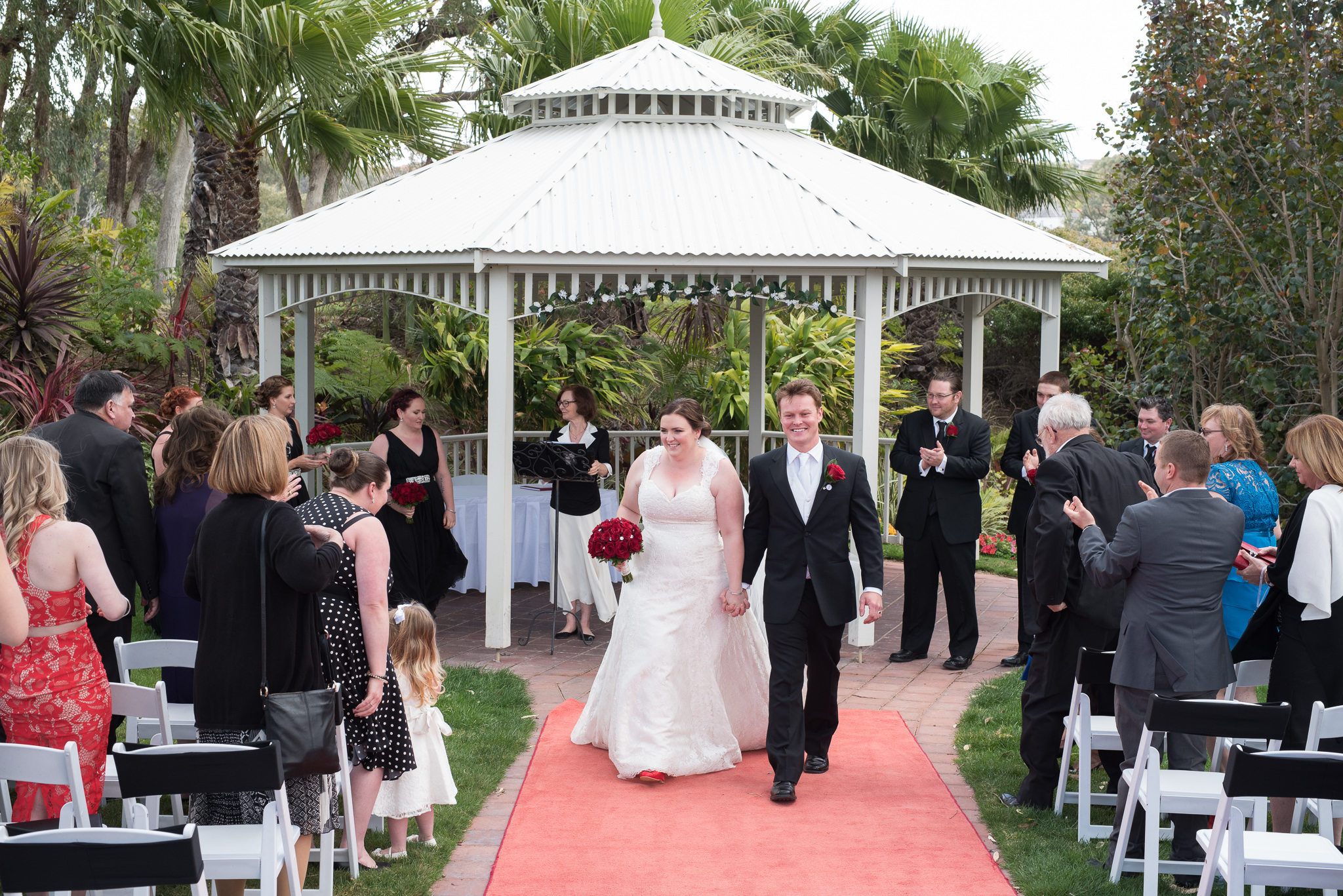 bride and groom walk back up the aisle together