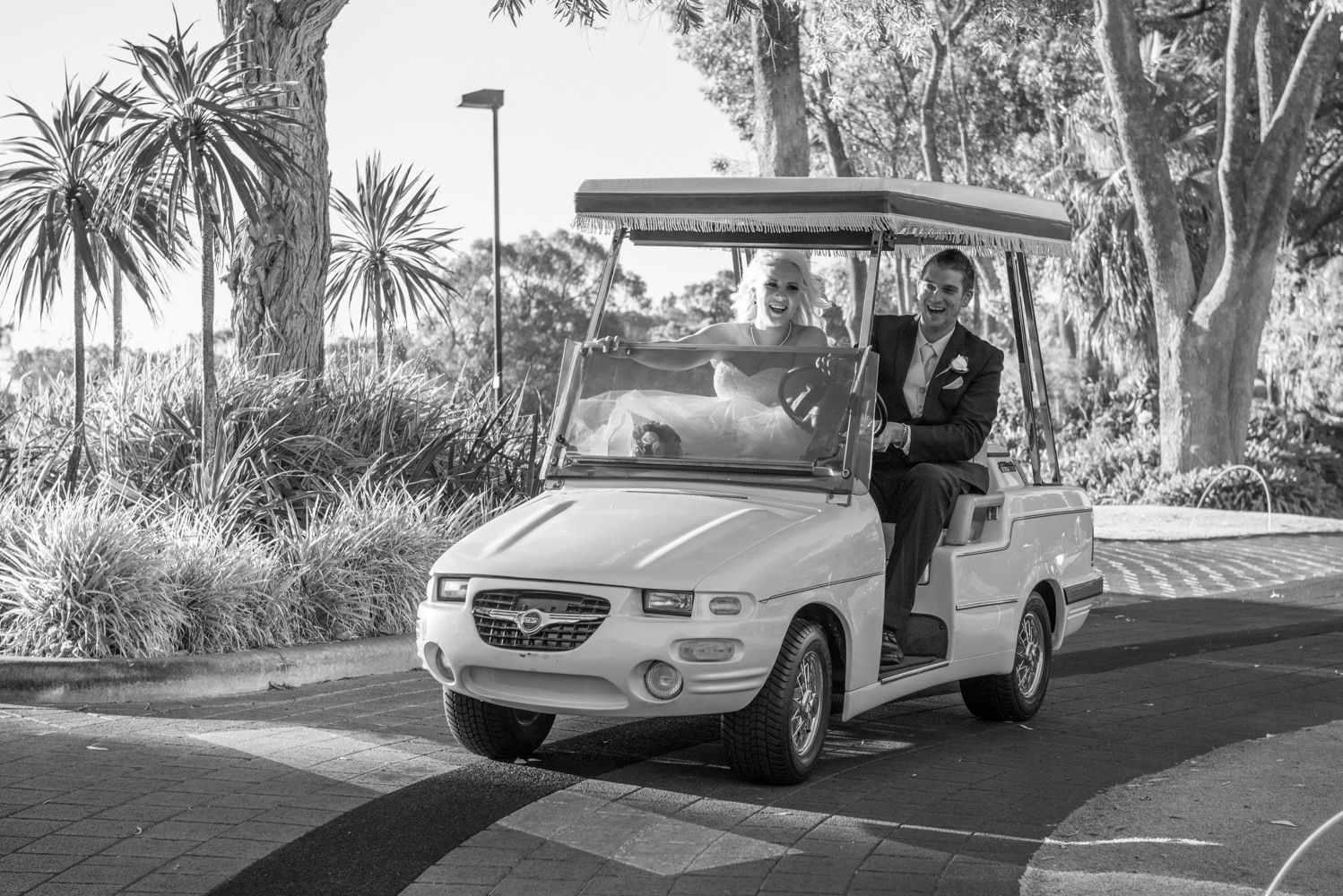 Bride and groom on golf cart