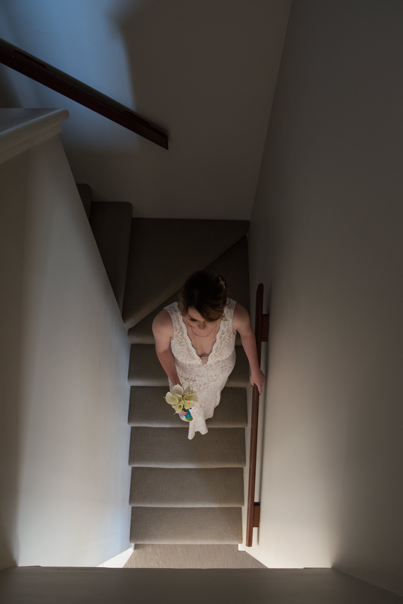 Bride walks down the stairs after getting ready for the wedding