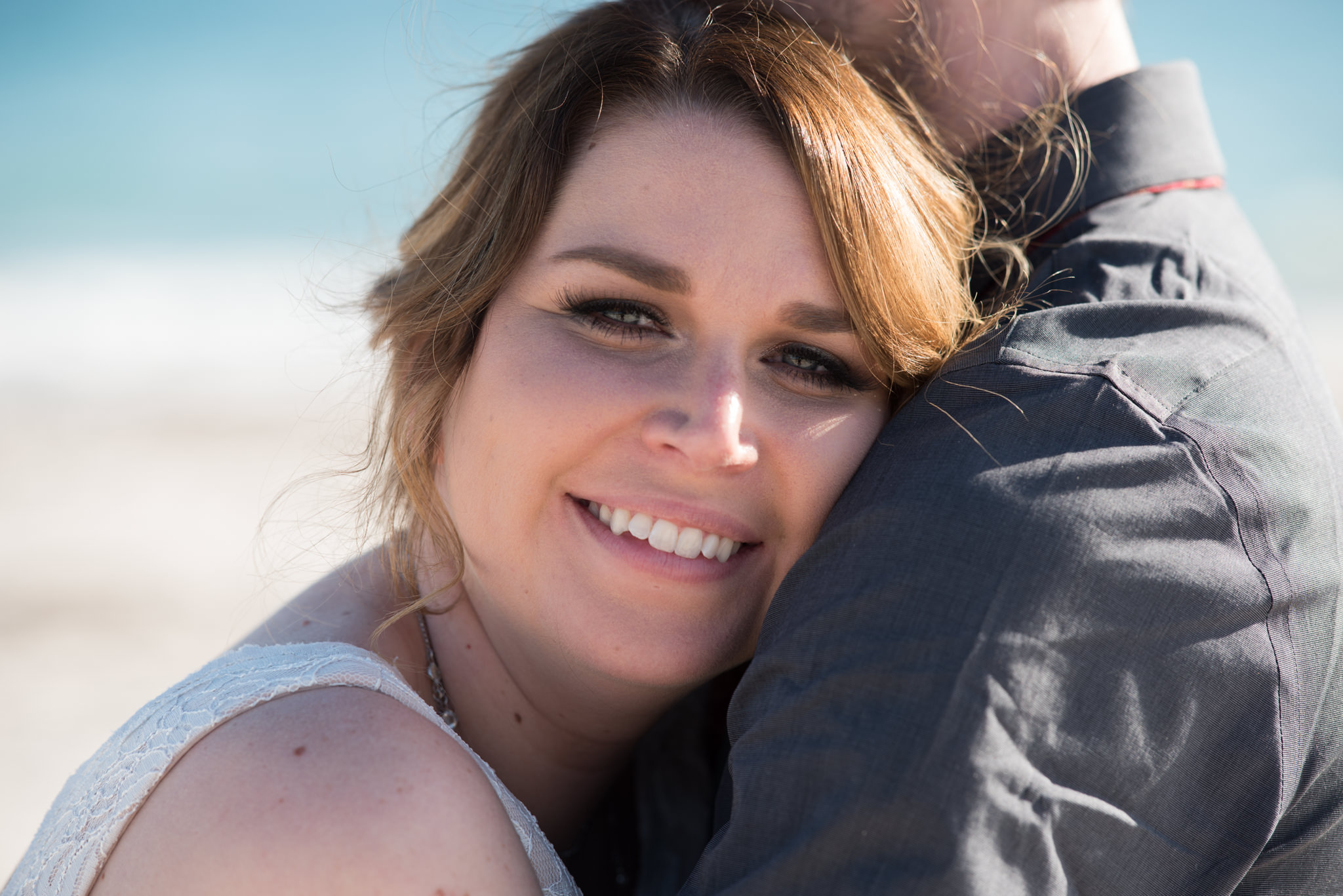 close up of a bride with her head resting on the groom's shoulder