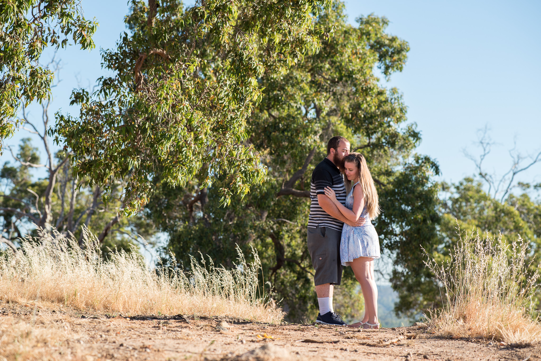 young couple in the bush holding each other