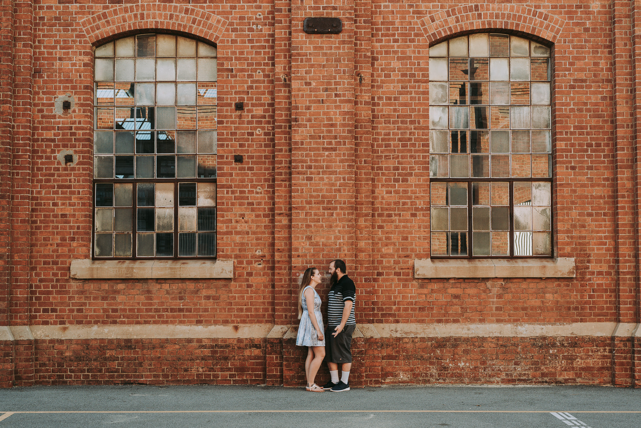 industrial building symmetrical with young couple in middle