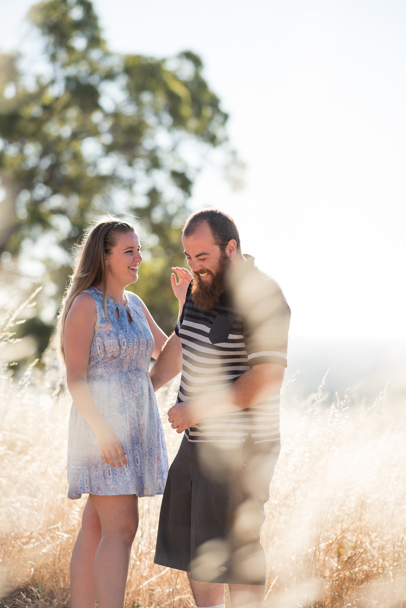 young couple having fun amongst the long reeds