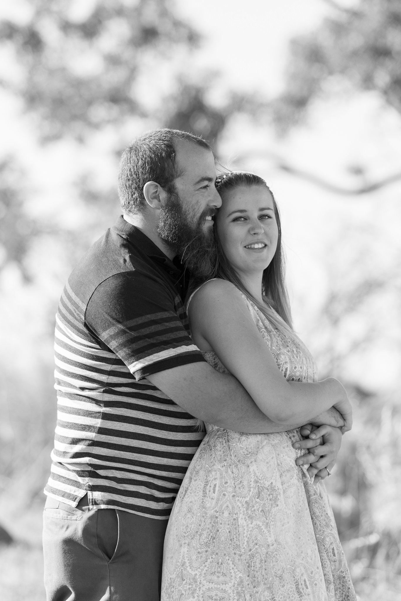 black and white portrait of couple cuddling