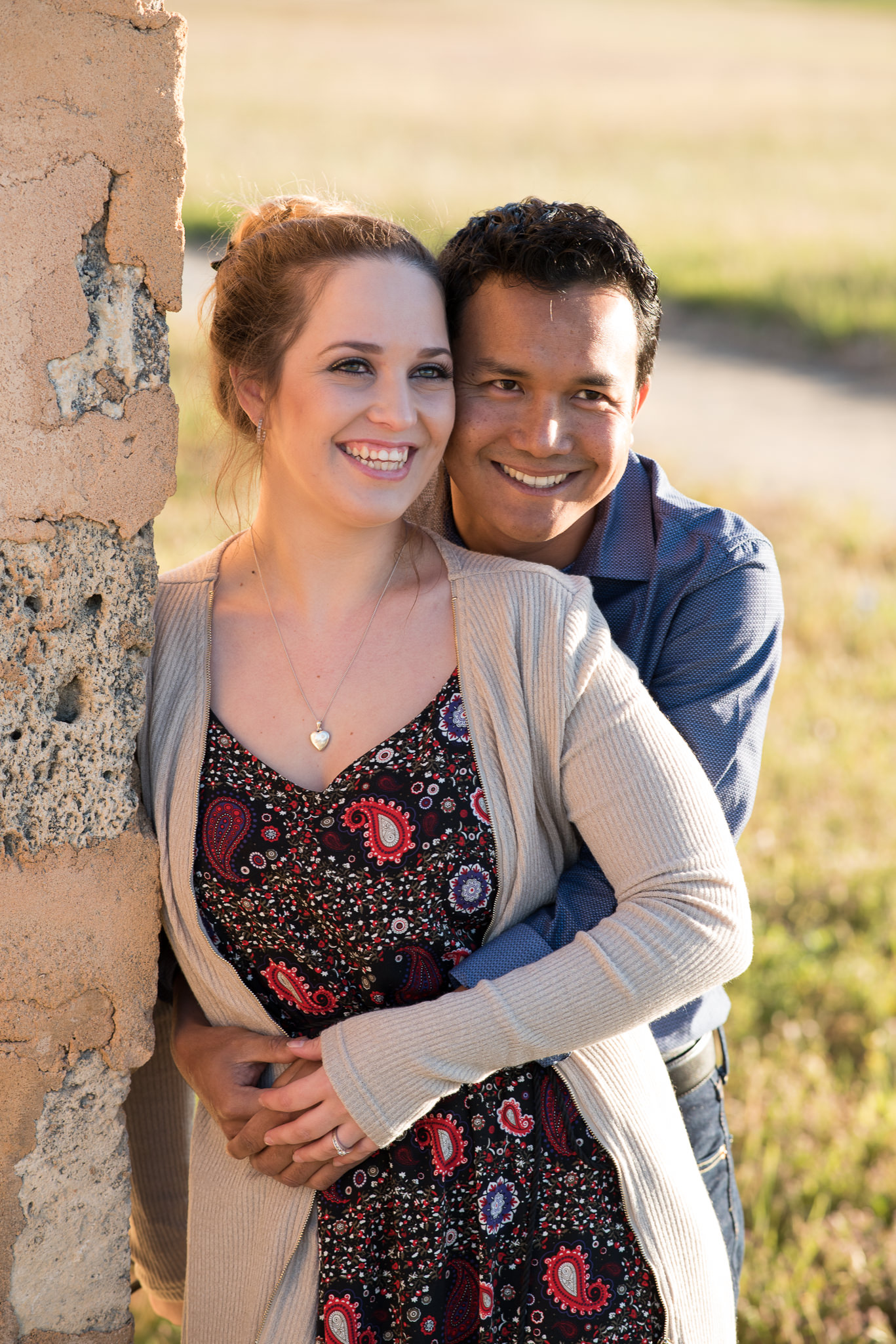 engaged couple give great smiles looking away