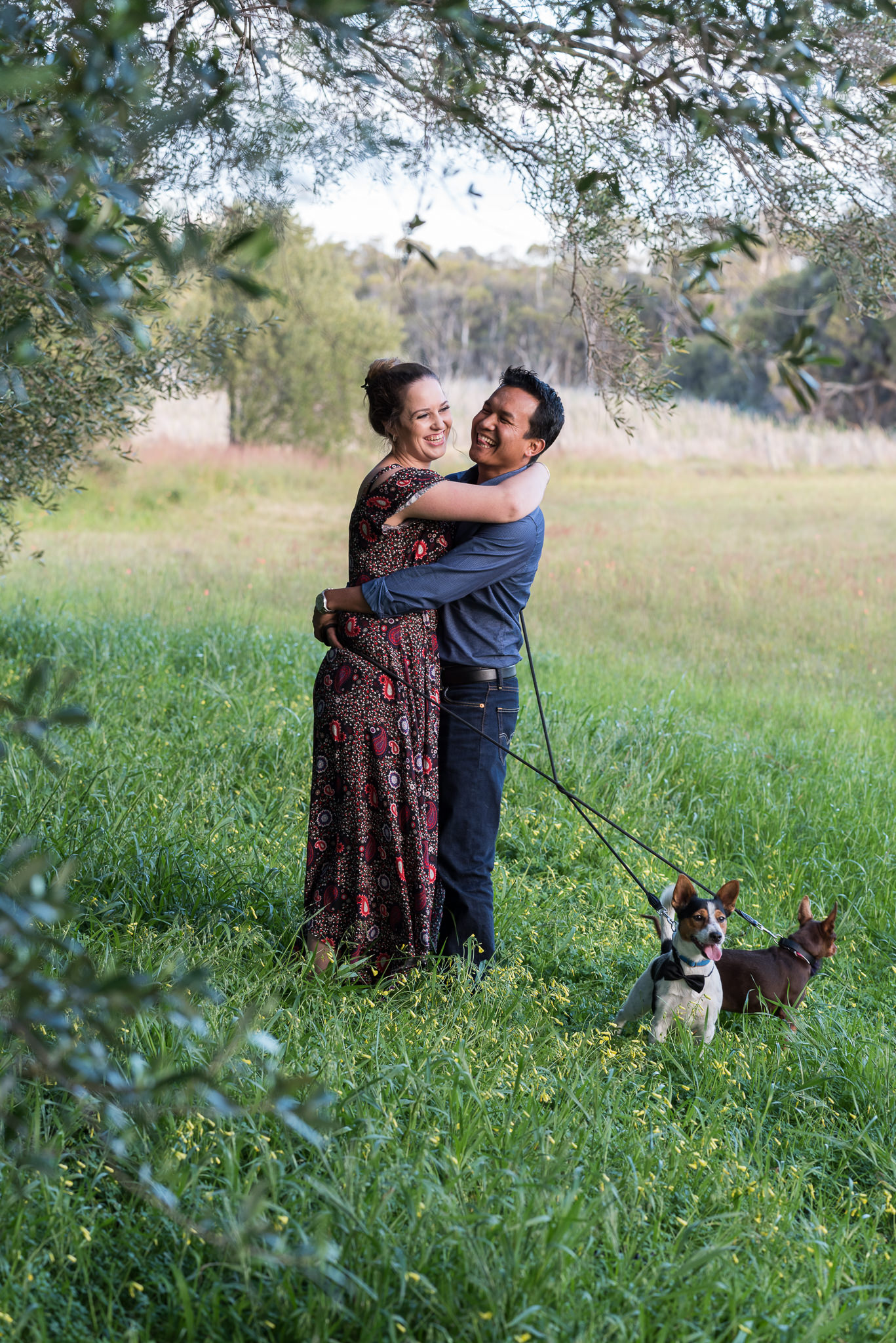 couple laughing together near trees