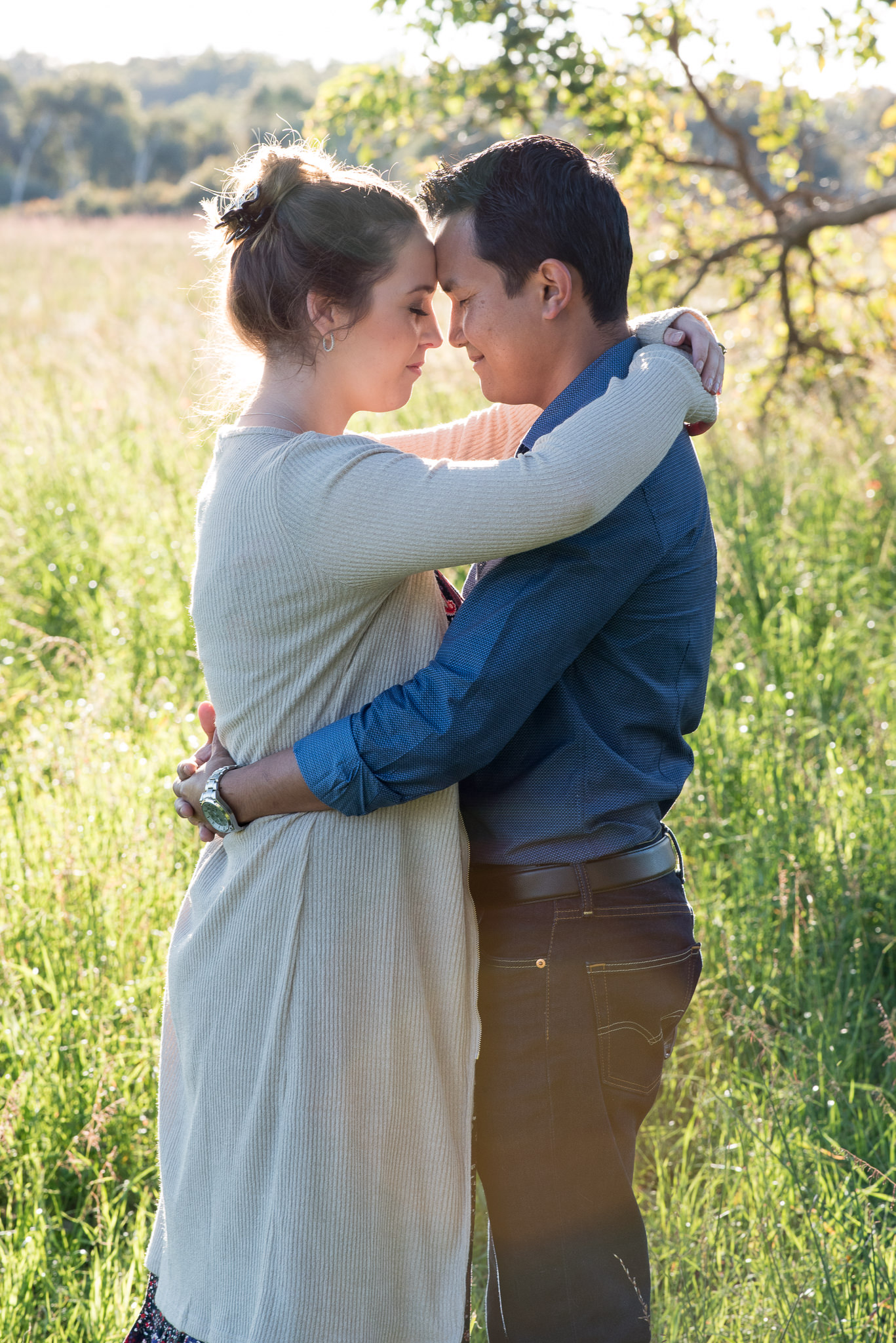 couple peacefully cuddling with their eyes shut