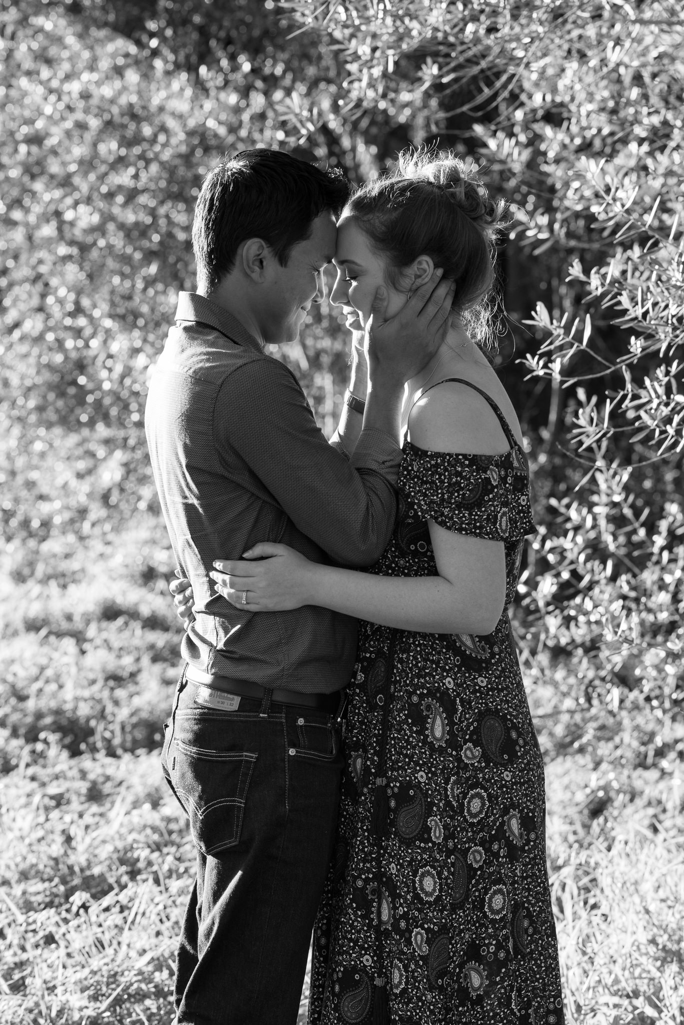 couple holding each other close smiling with eyes shut