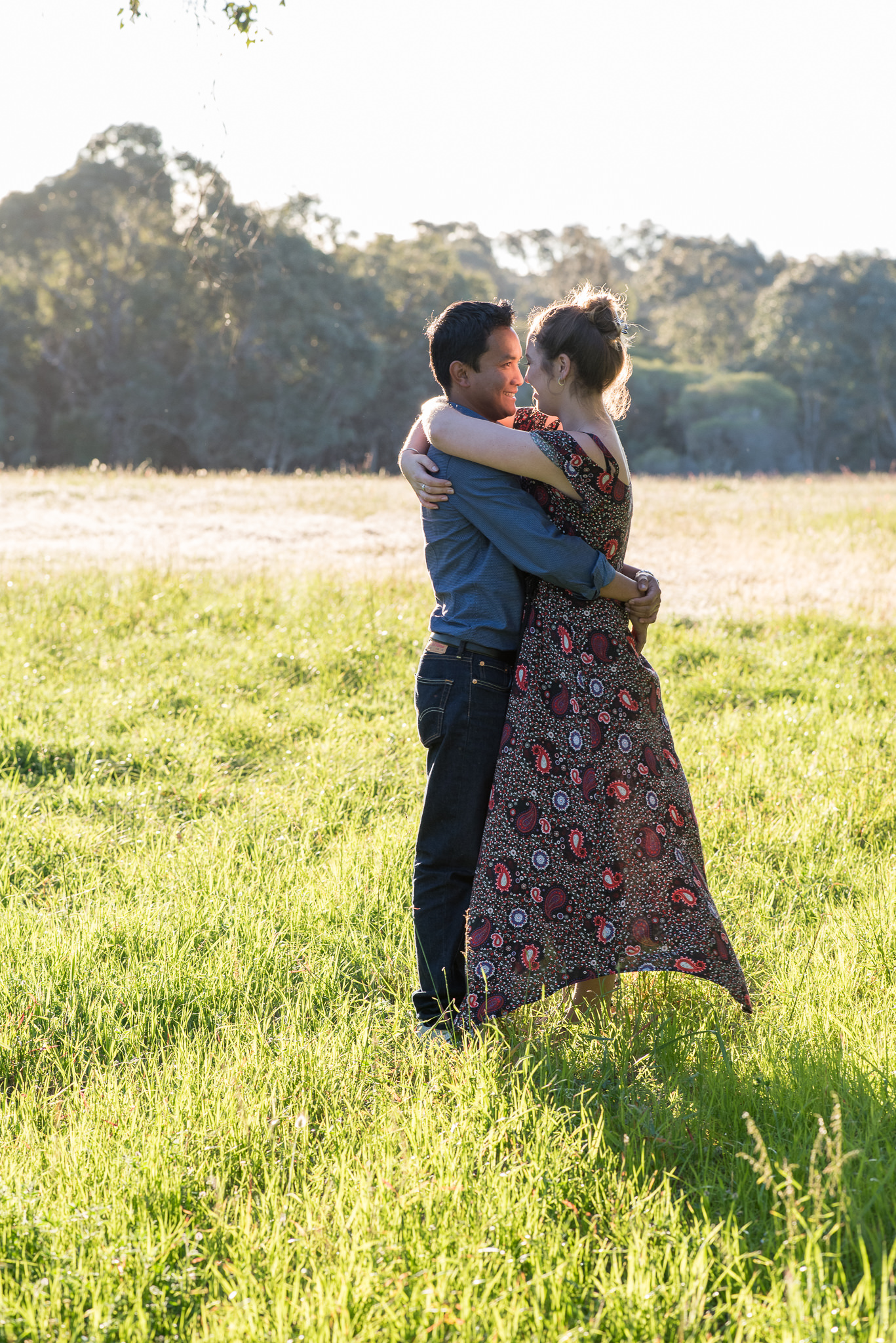 full length of couple in a field of green grass