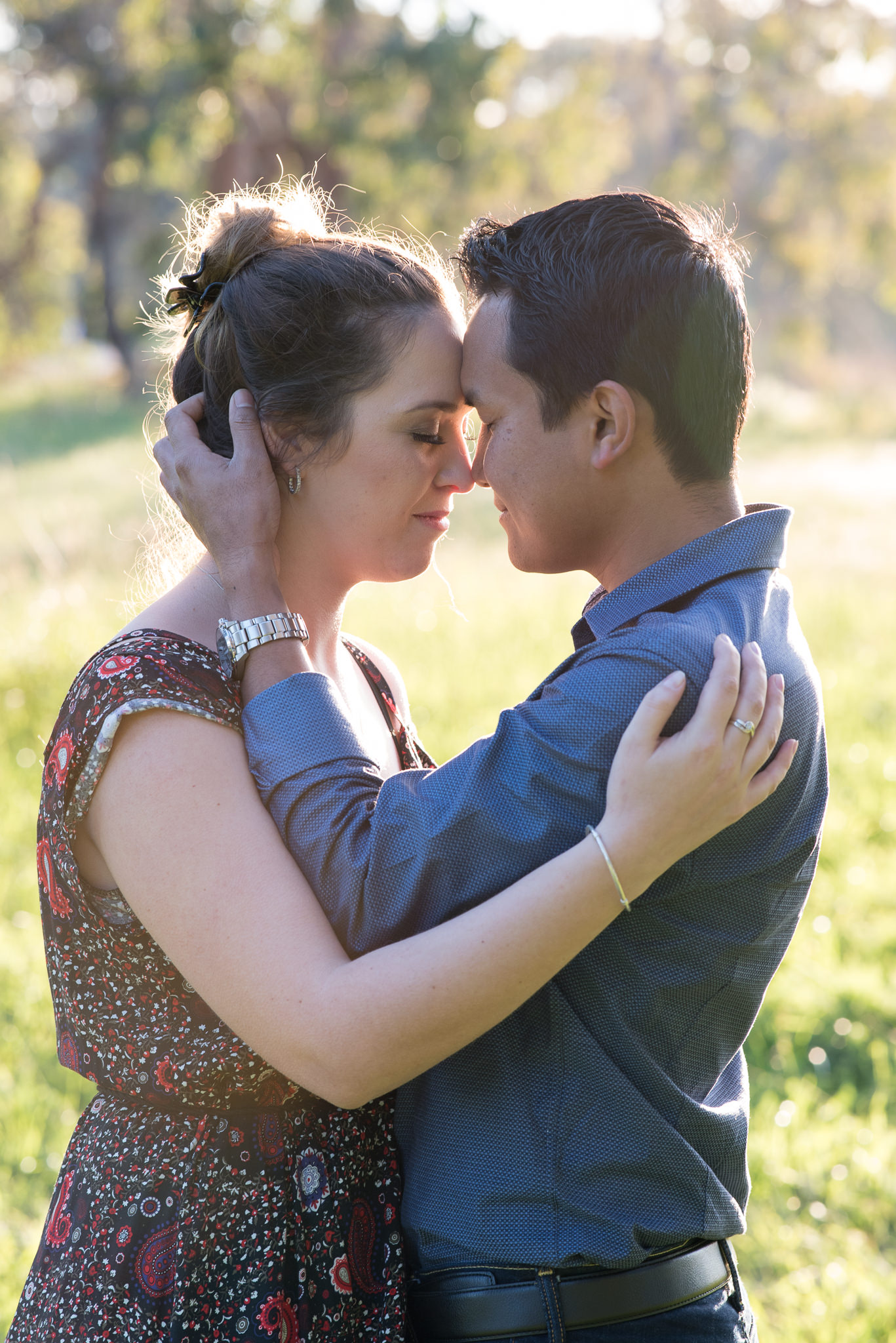 couple holding each other with closed eyes and hands on face