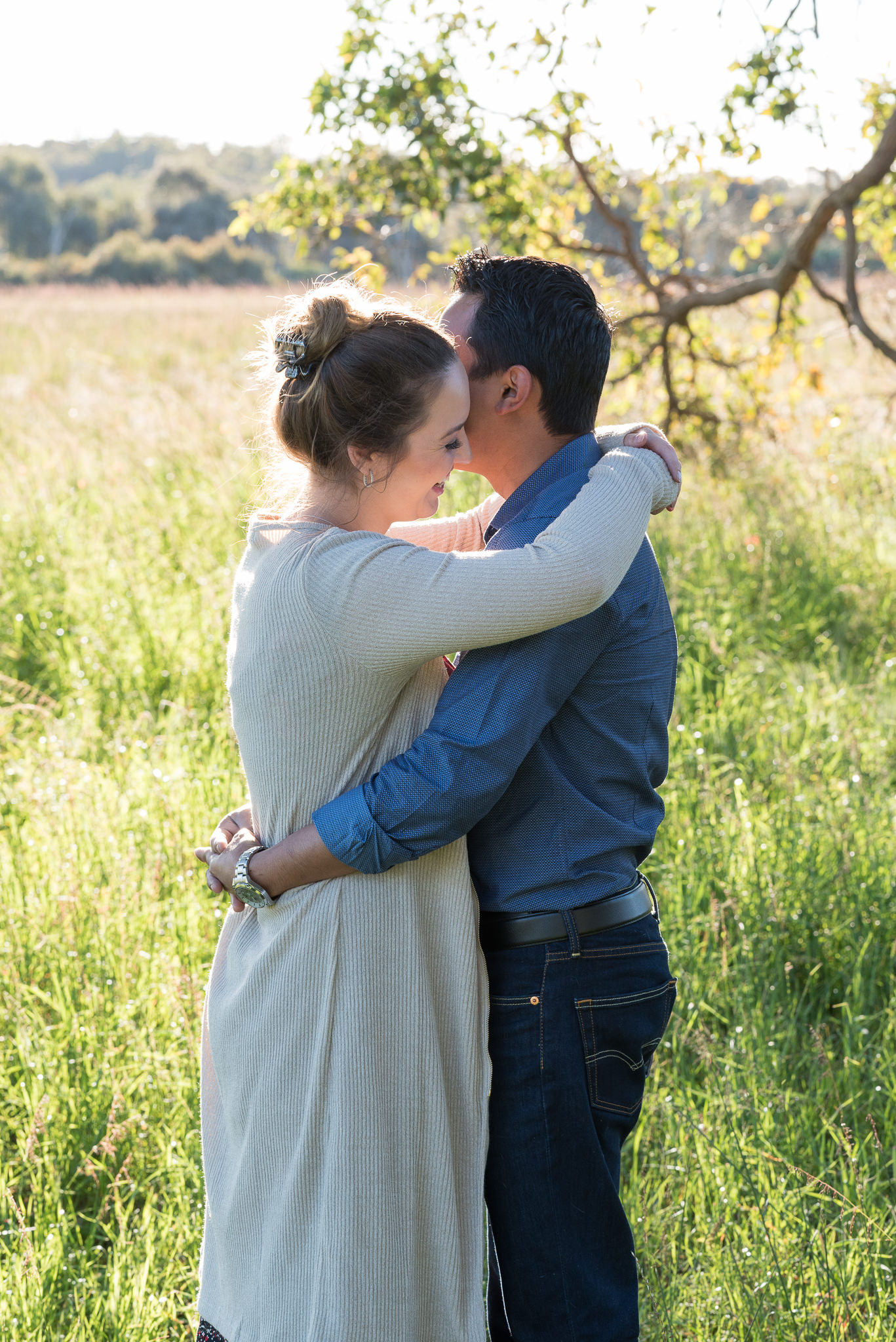 couple relaxed hugging in grass