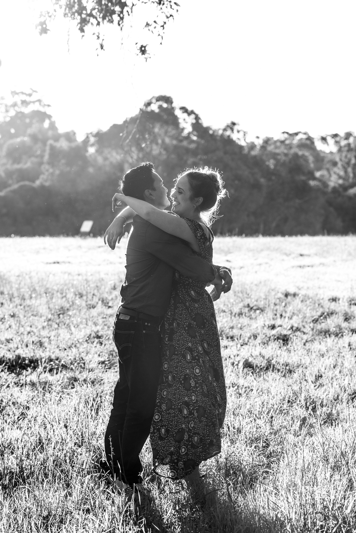 couple having a fun hug in afternoon light