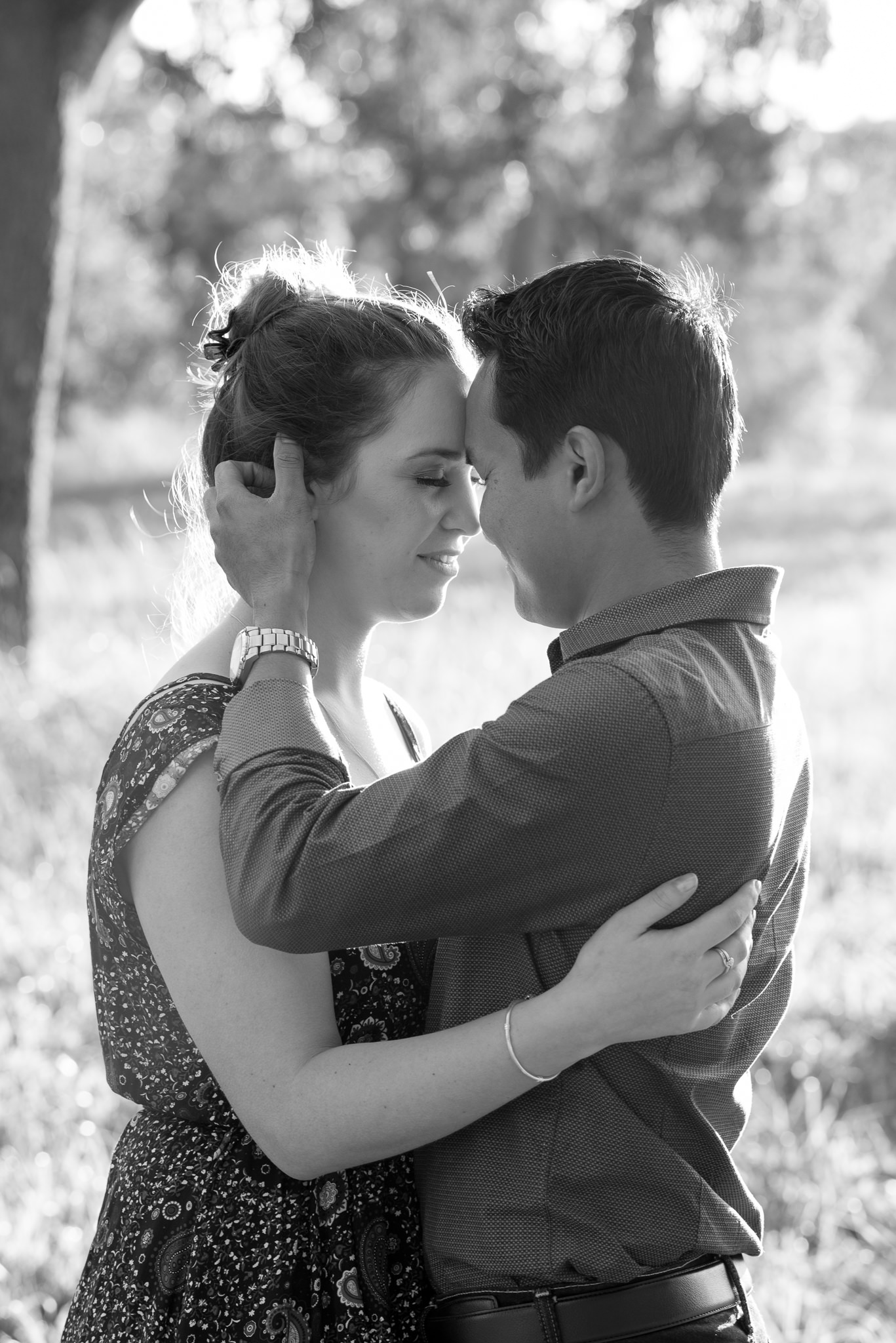 couple cuddling with eyes closed in black and white