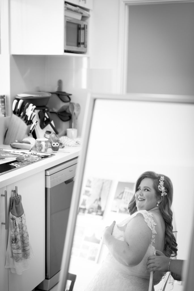 bride looks at herself in her mirror