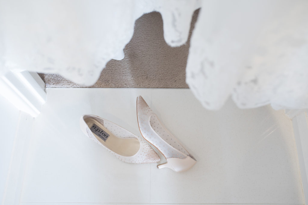 bridal shoes beneath wedding dress