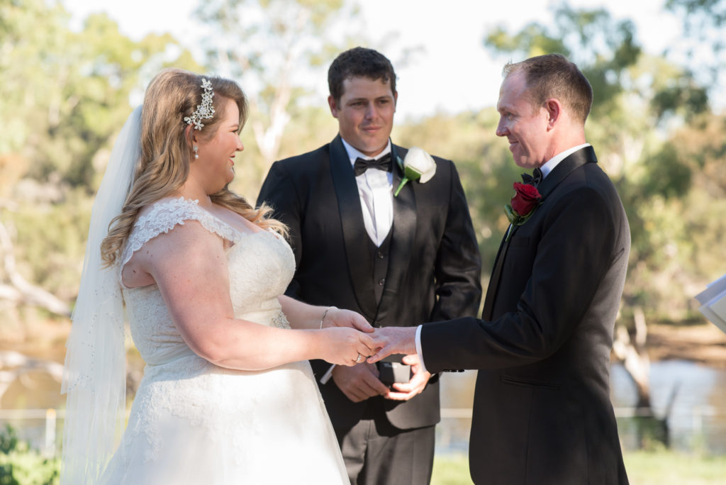 bride and groom exchanging rings