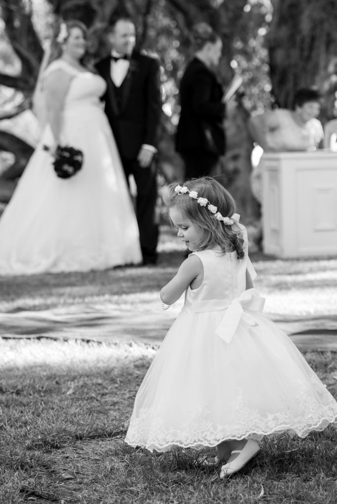 little flower girl twirling during wedding ceremony