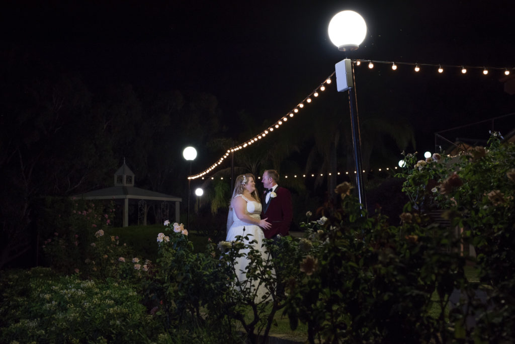 bride and groom walking in the night at their reception at Mulberry Estate