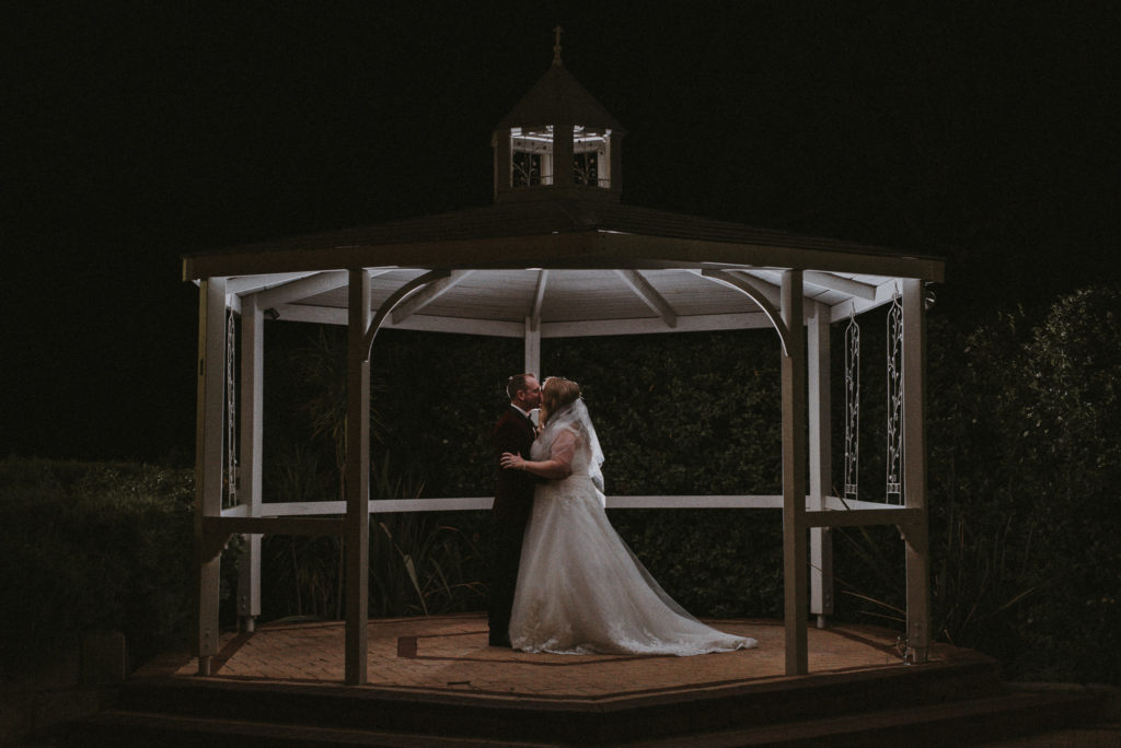 bride and groom backlit kissing in the rotunda at Mulberry Estate