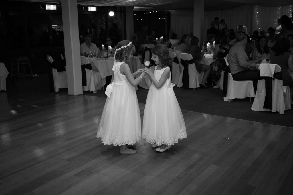 flower girls holding a rose on the dance floor