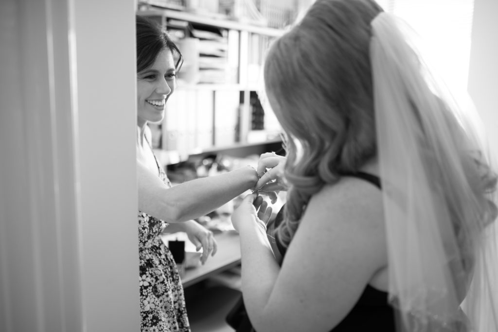 bridesmaid having bracelet put on