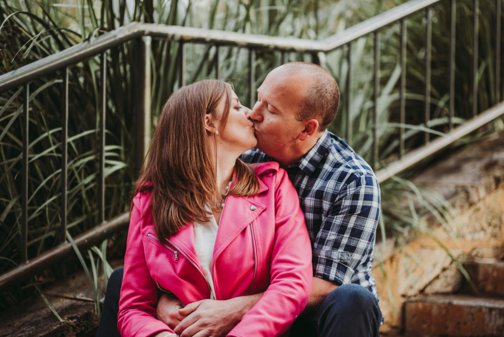 couple sitting on a step and kissing