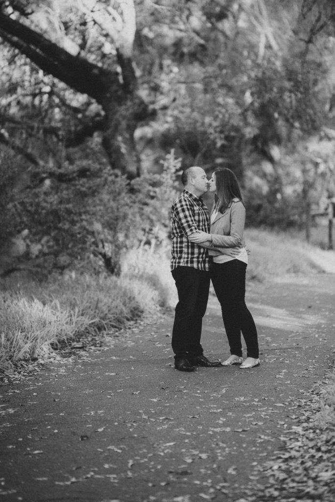 portrait of couple leaning in for a kiss