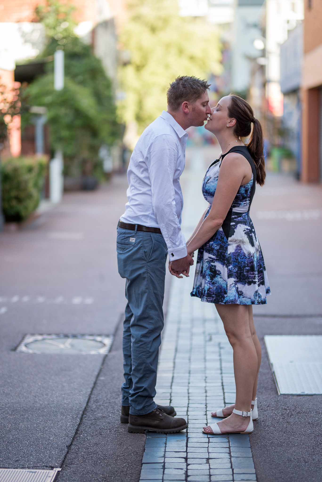 Engaged couple holding hands about to kiss in Wolf Lane