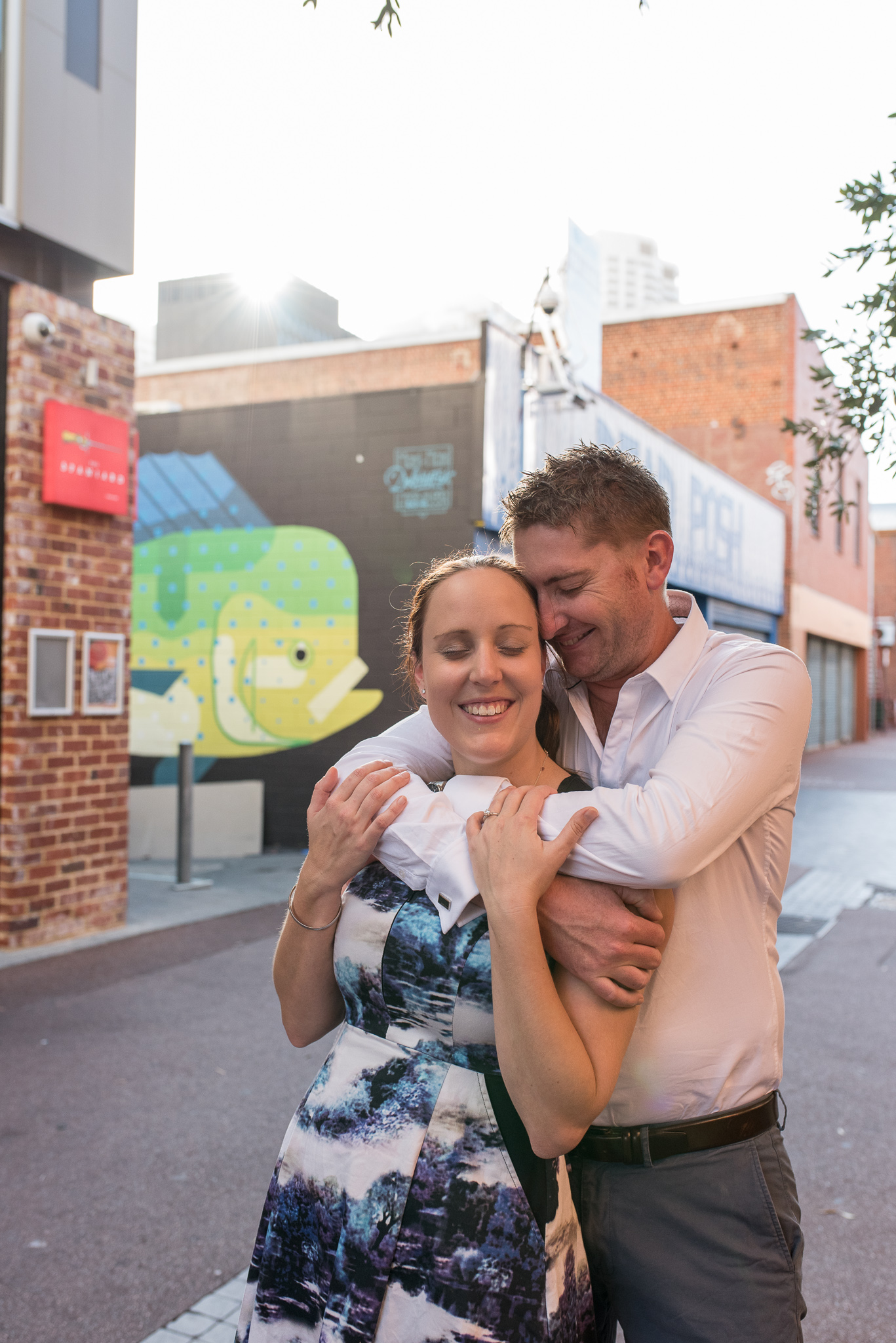 Portrait of engaged couple hugging on Wolf Lane and smiling