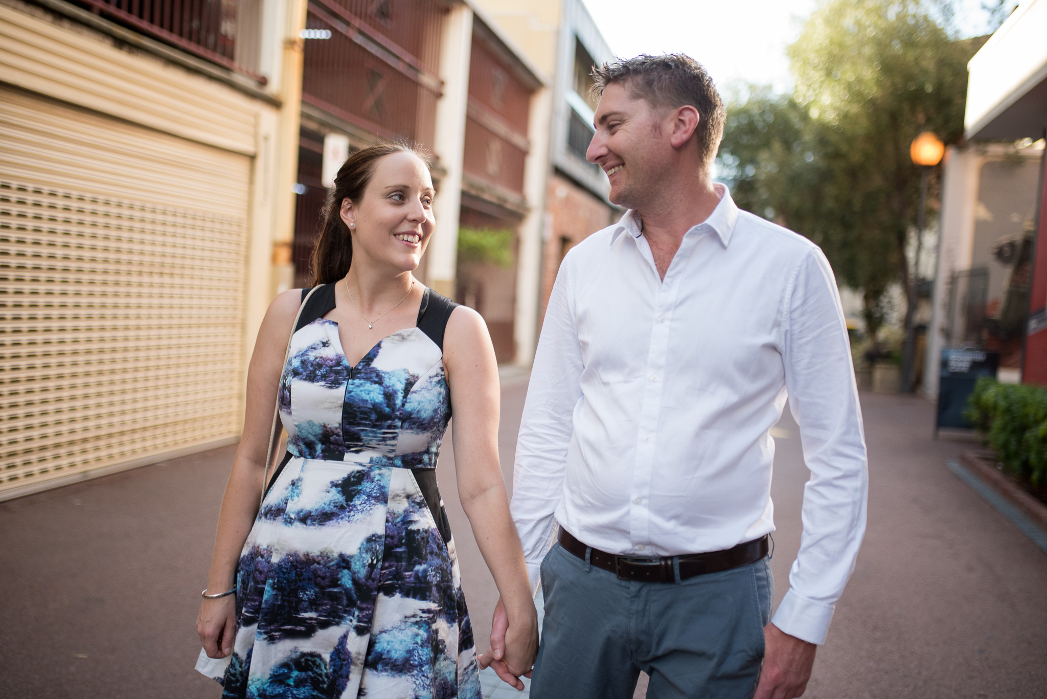 Portrait of engaged couple walking down Wolf Lane, smiling