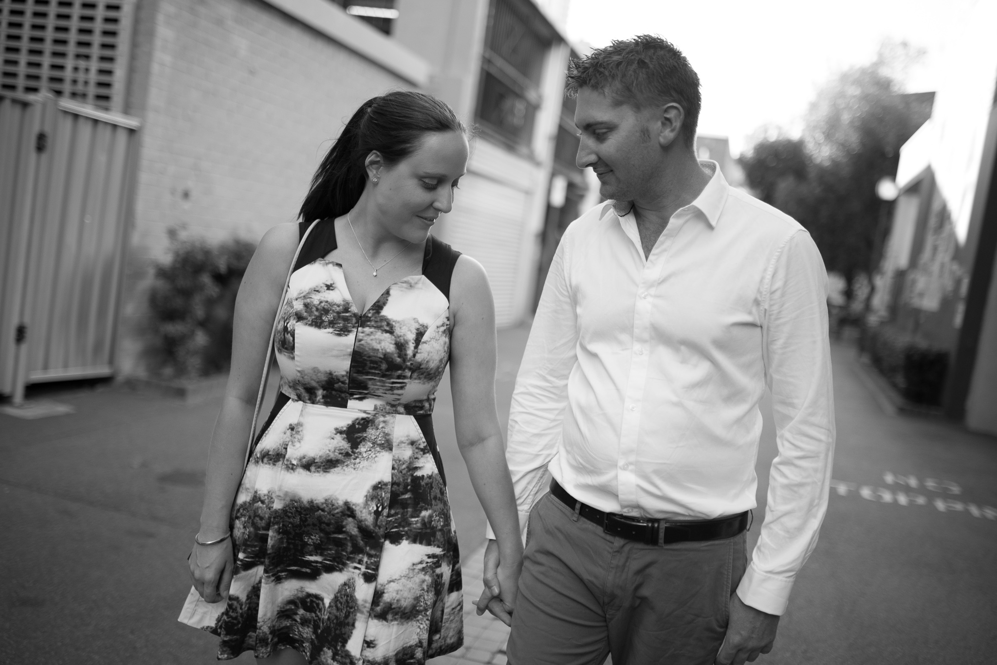 Black and white portrait of engaged couple walking down Wolf Lane