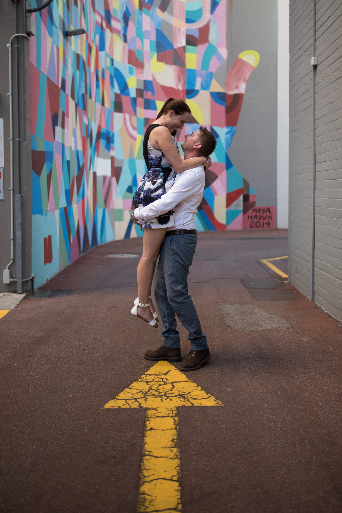 Engagement shoot at Wolf Lane with Maya Hayuk mural behind