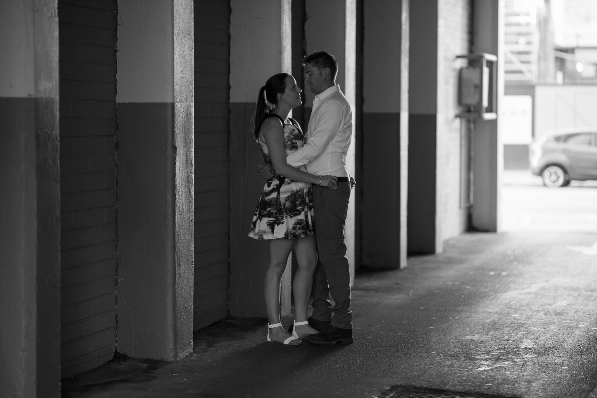 A Black and White low key portrait of engaged couple in the city