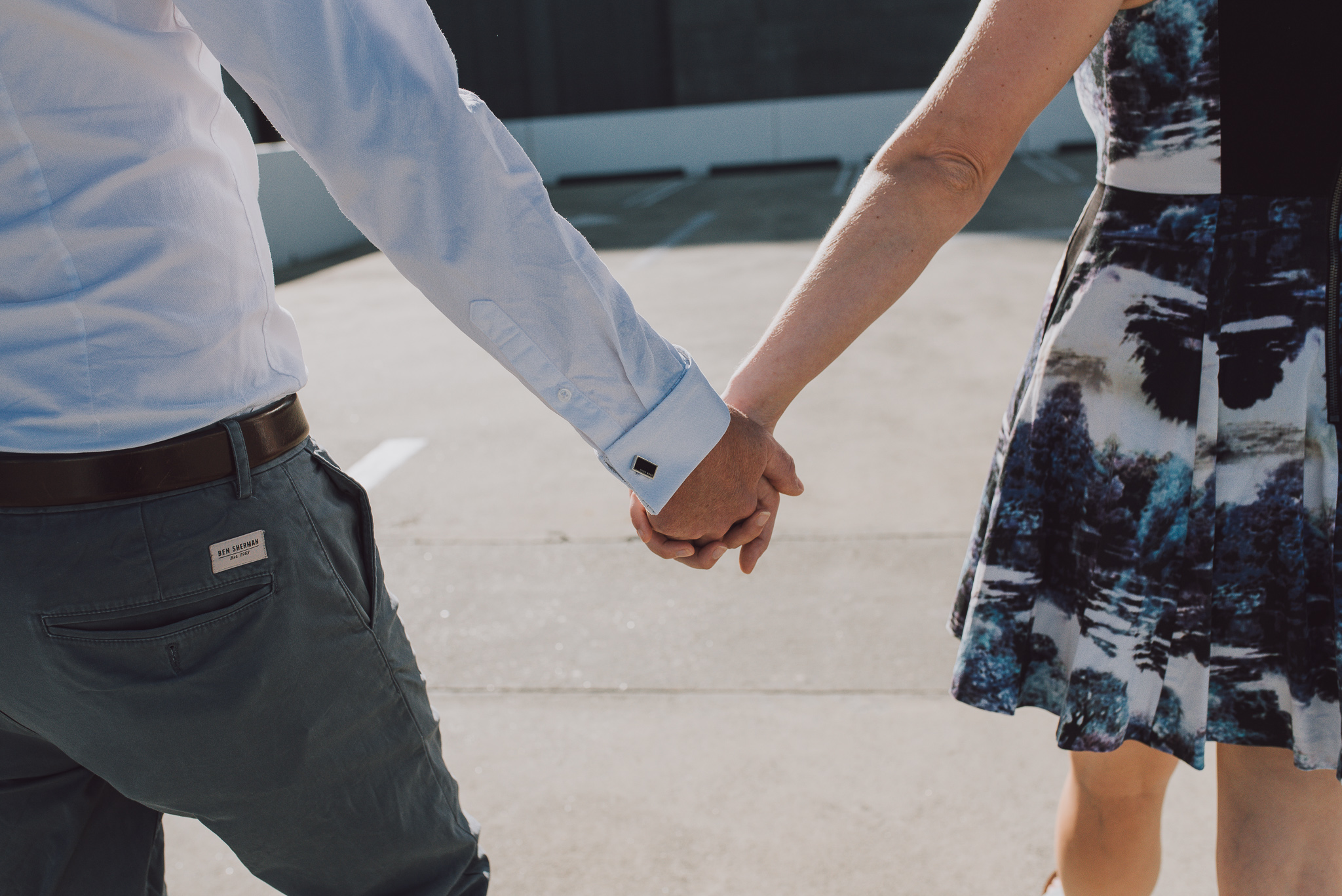 Closeup of engaged couple holding hands on Perth carpark rooftop