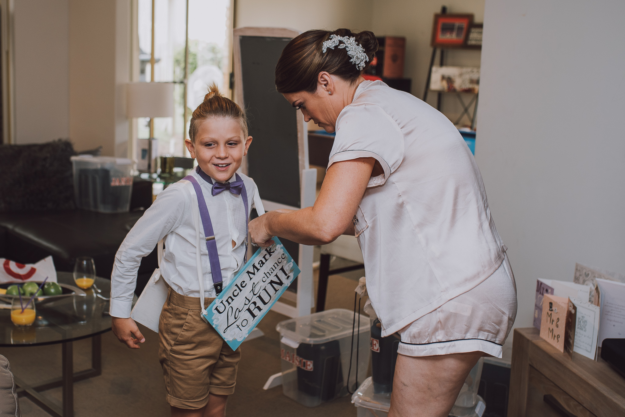 Bride puts page boy sign on him