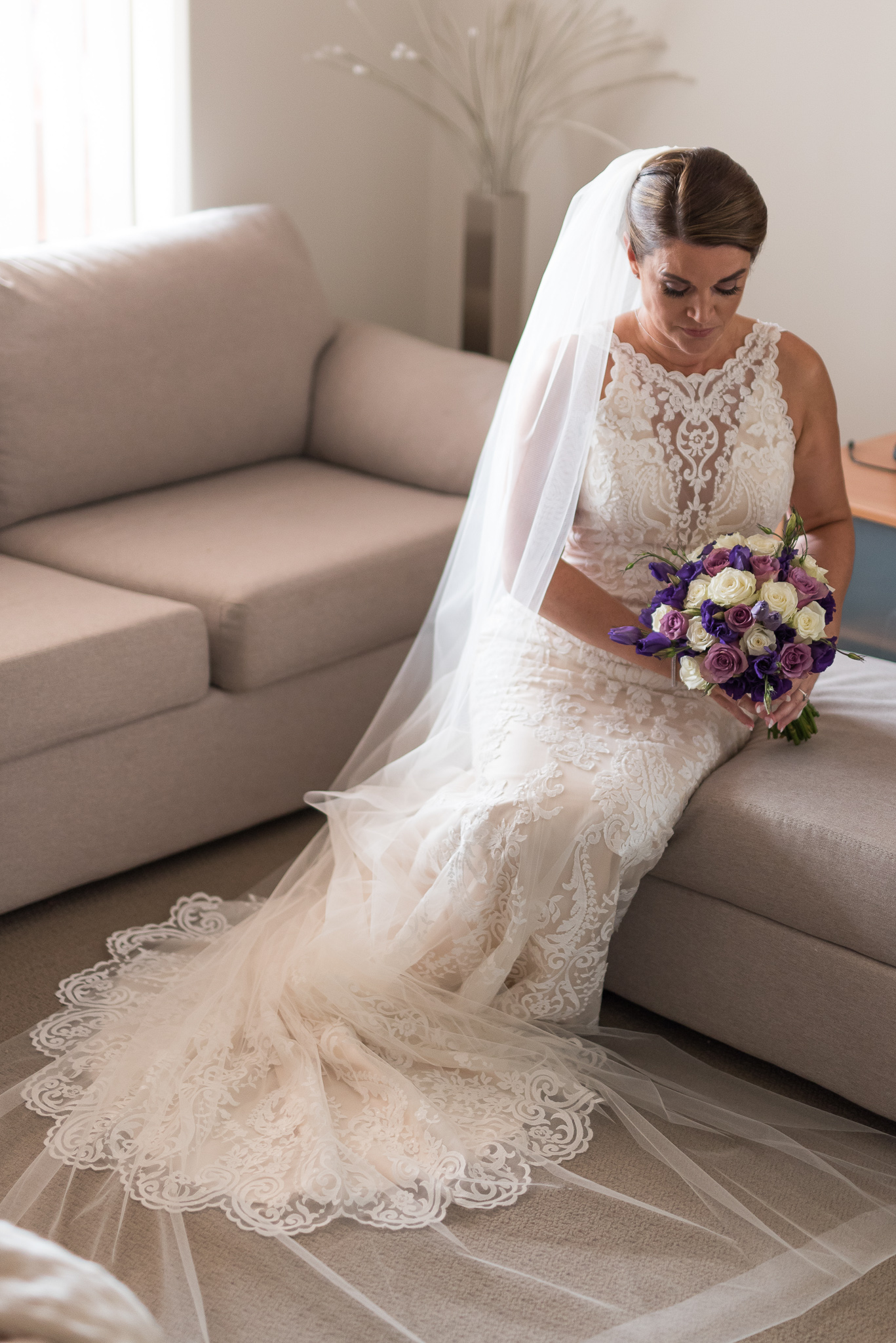 Elegant bride sits on the edge of her lounge