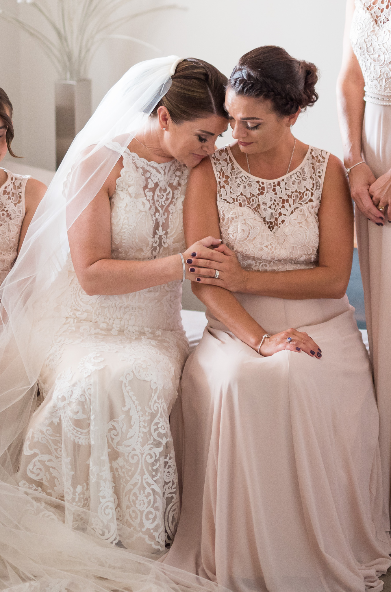 bride and sister share a moment getting ready