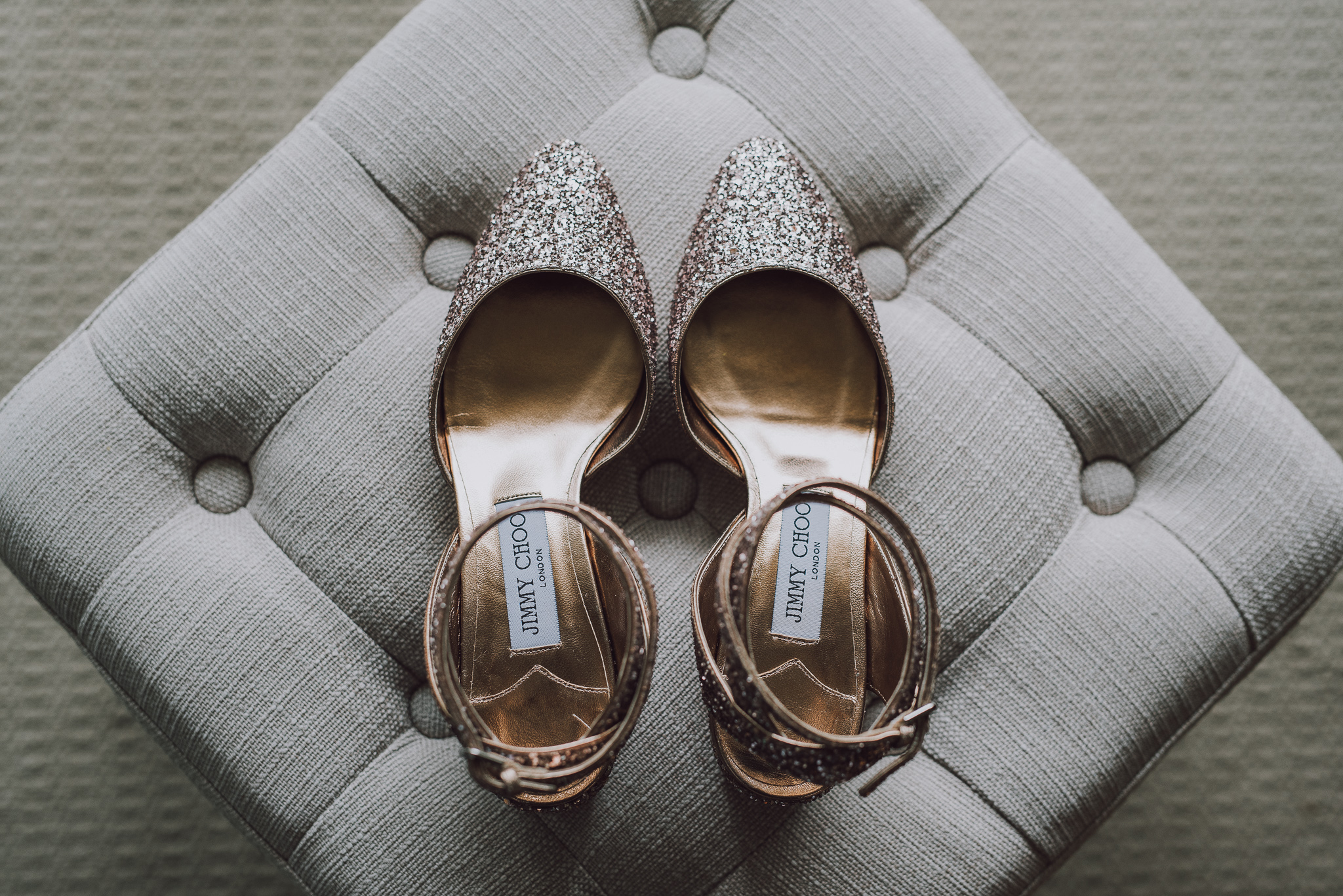 Flat lay of Jimmy Choo bridal shoes on an ottoman