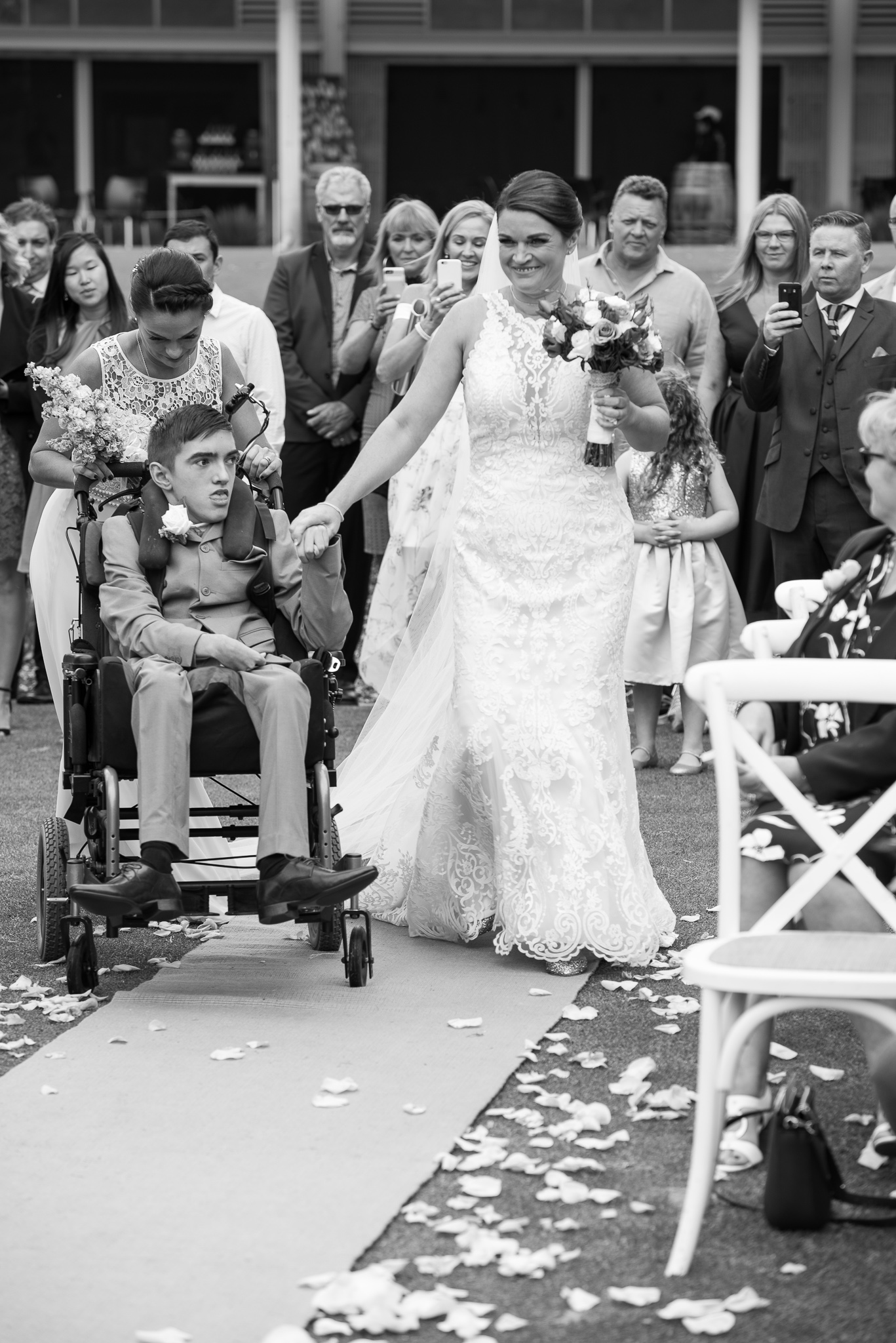 bride is walked down the aisle by her son